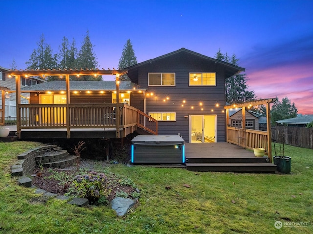 back house at dusk with a pergola, a wooden deck, a yard, and a hot tub