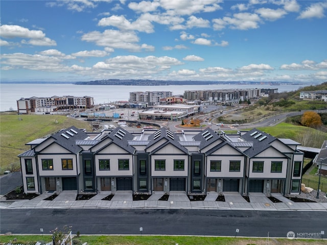 birds eye view of property with a water view