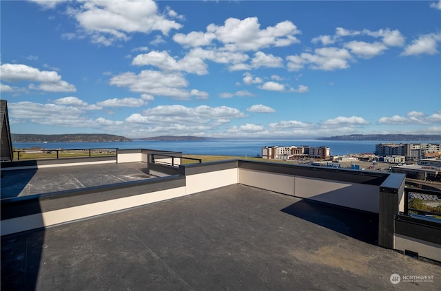 view of patio / terrace featuring a water and mountain view