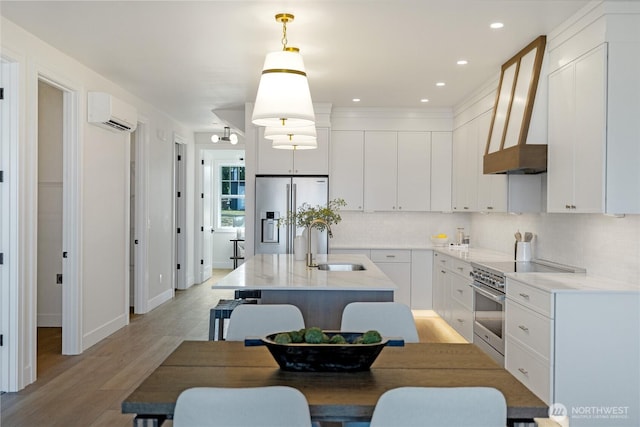 5129 N Bennett St, Ruston, WA 98407 - kitchen with stainless steel appliances, backsplash, a sink, custom exhaust hood, and a wall mounted AC