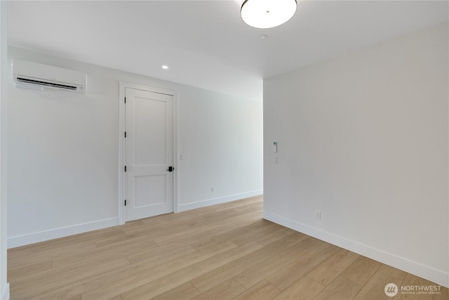 5129 N Bennett St, Ruston, WA 98407 - empty room featuring a wall unit AC, light wood-style floors, baseboards, and recessed lighting