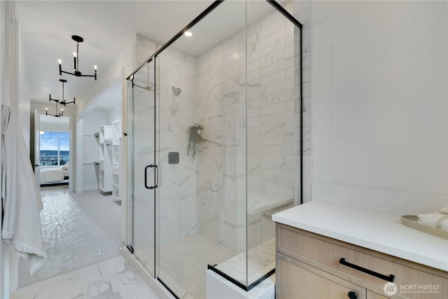 bathroom featuring marble finish floor, a marble finish shower, recessed lighting, connected bathroom, and a notable chandelier