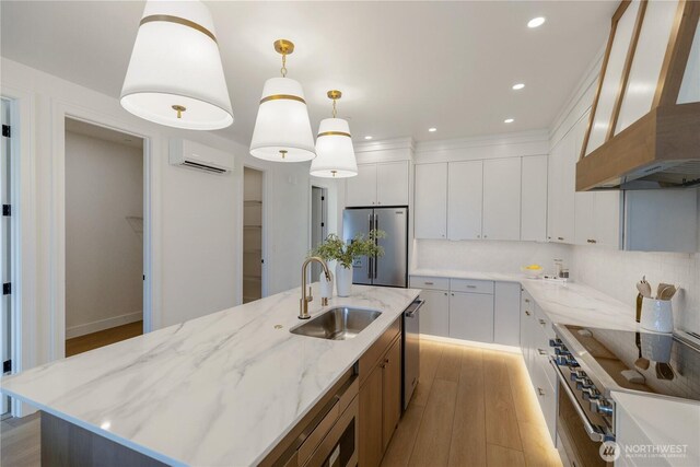 5123 N Bennett St, Ruston, WA 98407 - kitchen with wall chimney exhaust hood, high quality appliances, a sink, a wall mounted air conditioner, and light wood-type flooring