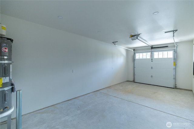 5123 N Bennett St, Ruston, WA 98407 - garage featuring strapped water heater and a garage door opener