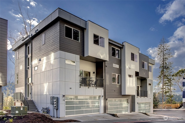 view of front of home featuring cooling unit and a garage