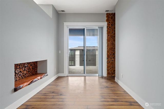 unfurnished living room with wood-type flooring