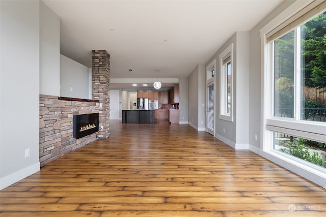 unfurnished living room with a fireplace and light hardwood / wood-style flooring