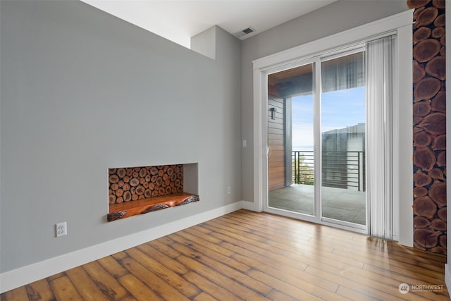 unfurnished living room with hardwood / wood-style flooring