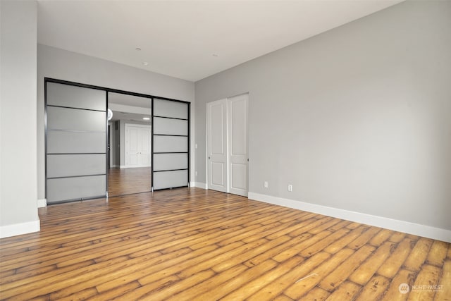 unfurnished bedroom featuring a closet and light hardwood / wood-style flooring