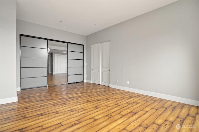 23840 7th Ave S Unit B101, Des Moines, WA 98198 - unfurnished bedroom featuring hardwood / wood-style floors and baseboards