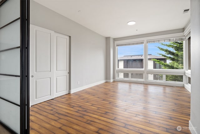 unfurnished bedroom featuring hardwood / wood-style flooring