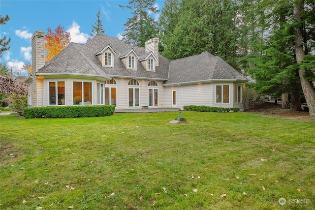 view of front of home featuring a front yard and a patio