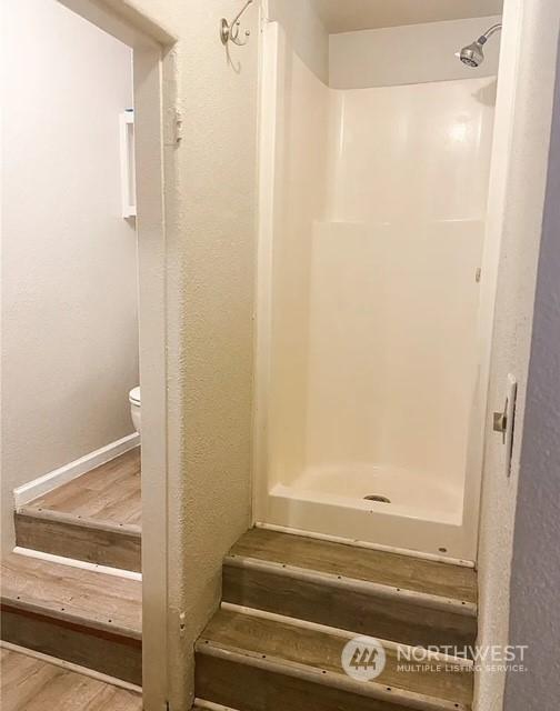 5503 112th St SW, Lakewood, WA 98499 - full bath with toilet, a shower, and wood finished floors