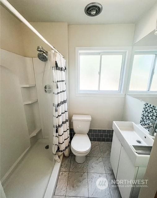 5503 112th St SW, Lakewood, WA 98499 - bathroom with plenty of natural light, a stall shower, toilet, and vanity