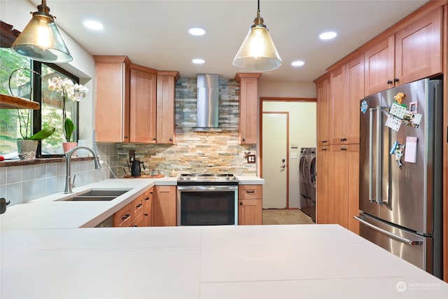 kitchen with decorative backsplash, wall chimney exhaust hood, stainless steel appliances, sink, and washer and dryer