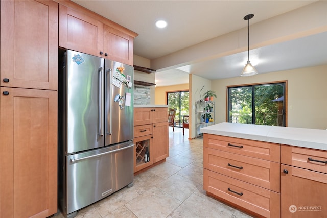 kitchen with high quality fridge and pendant lighting