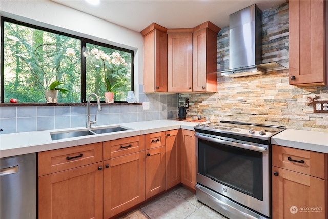 kitchen featuring appliances with stainless steel finishes, tasteful backsplash, wall chimney exhaust hood, and sink