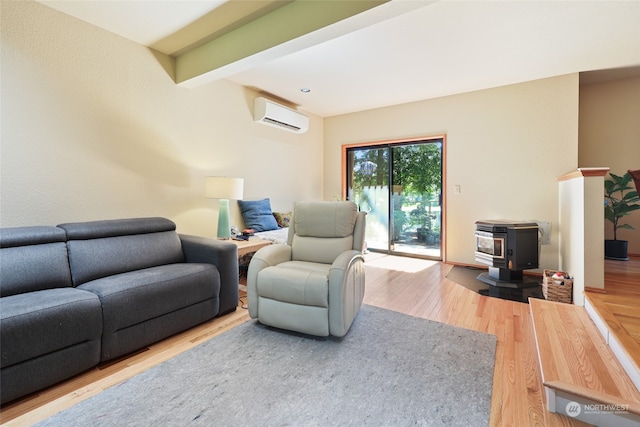 living room featuring a wood stove, hardwood / wood-style floors, beamed ceiling, and a wall mounted air conditioner