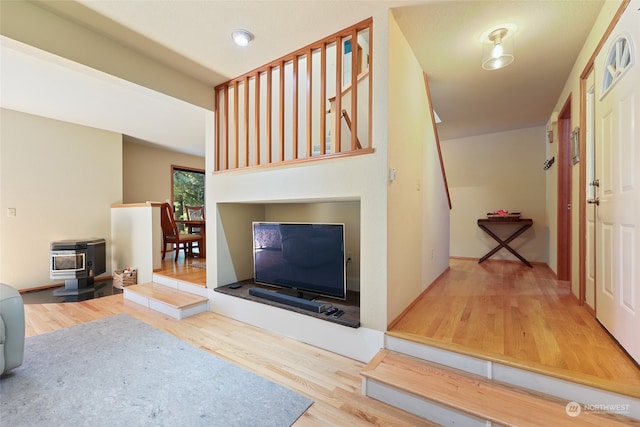 living room featuring hardwood / wood-style flooring and a wood stove