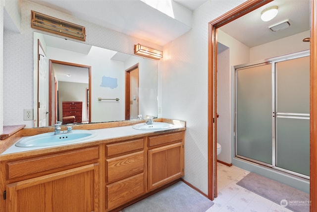 bathroom with vanity, toilet, and walk in shower