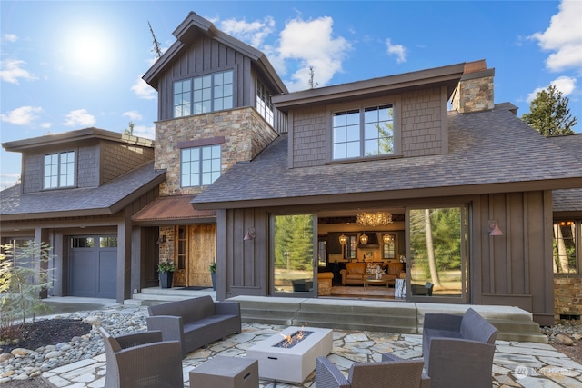 rear view of house featuring an outdoor living space with a fire pit