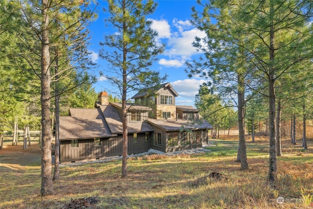 back of house featuring a sunroom