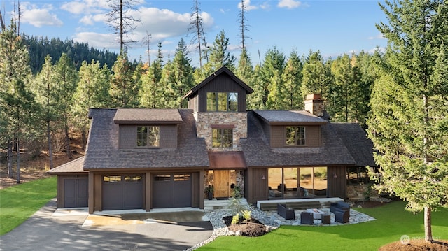 view of front of home with a front yard and a garage