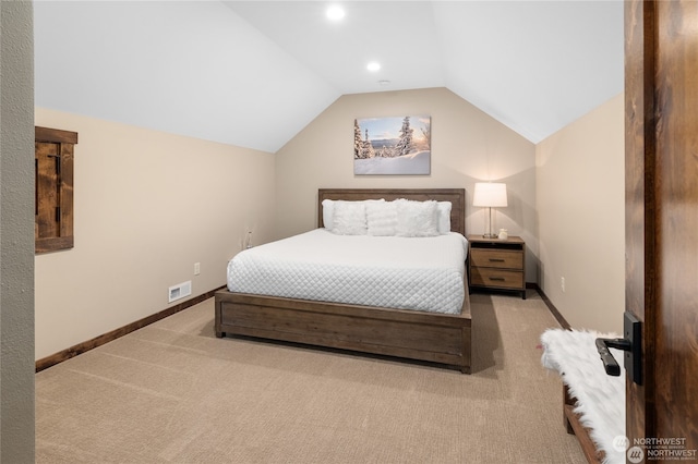 bedroom featuring light colored carpet and vaulted ceiling