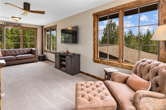 carpeted living room featuring ceiling fan