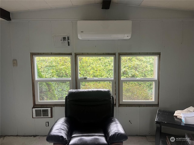 23009 V St, Ocean Park, WA 98640 - living area featuring an AC wall unit, vaulted ceiling, healthy amount of natural light, and a wall mounted AC