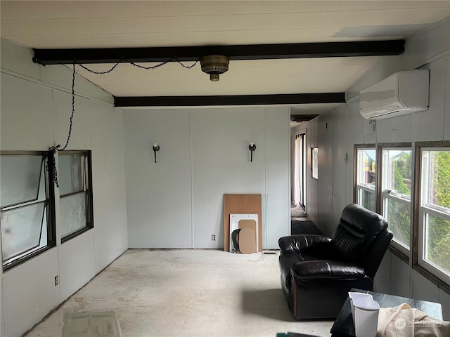 23009 V St, Ocean Park, WA 98640 - living area featuring a wall mounted air conditioner, beamed ceiling, and concrete flooring