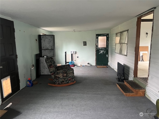 sitting room featuring dark colored carpet