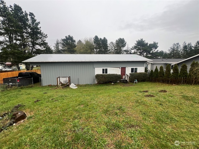 back of house with a lawn