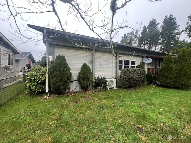 view of side of property featuring a yard