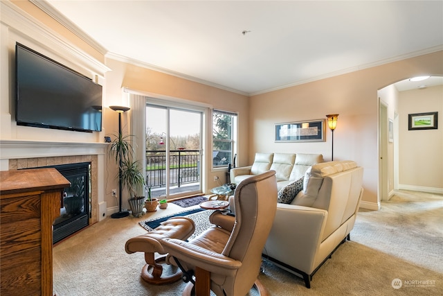 living room with light colored carpet, crown molding, and a tiled fireplace