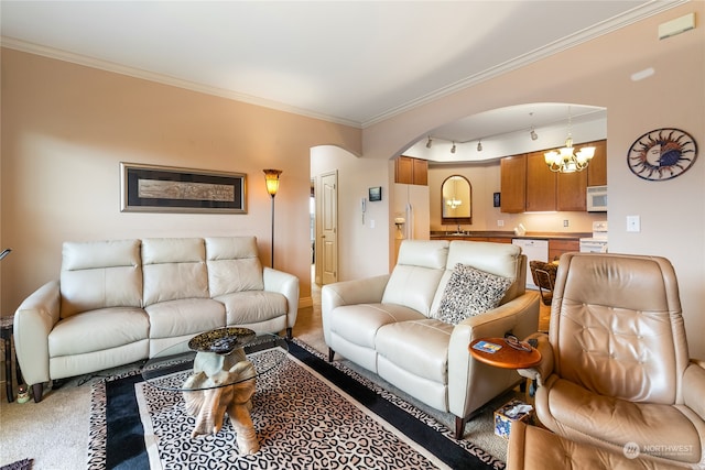 living room with track lighting, crown molding, sink, an inviting chandelier, and carpet floors