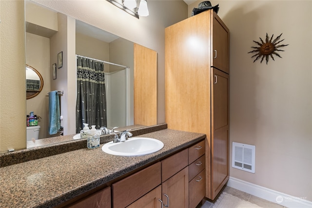 bathroom featuring tile patterned flooring, vanity, and a shower with shower curtain