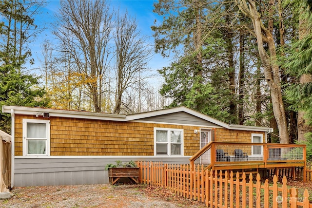 rear view of house featuring a deck