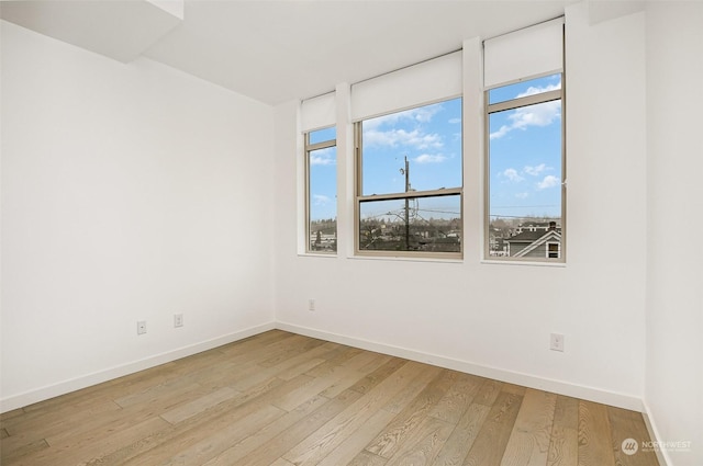 spare room featuring light wood-type flooring