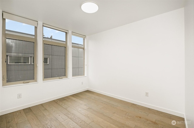 unfurnished room with light hardwood / wood-style floors