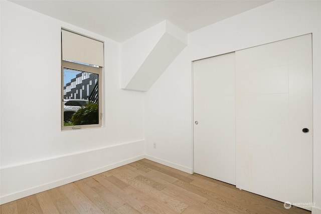 bonus room with light wood-type flooring