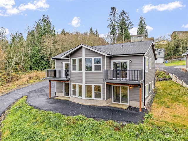 back of house featuring a lawn, a patio area, and a deck