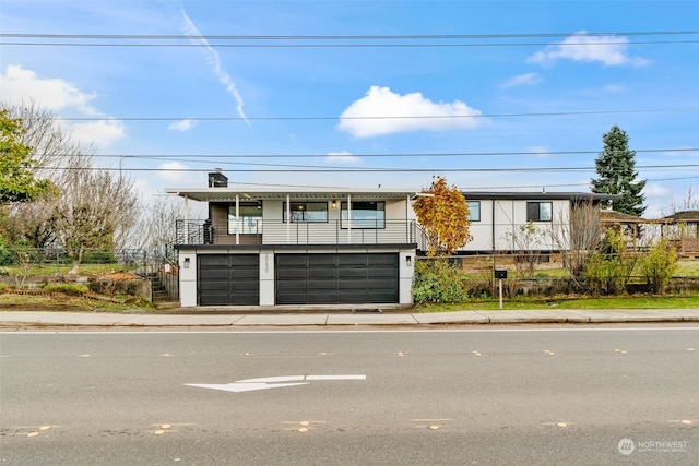 view of front of house with a balcony and a garage