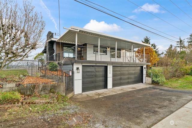 view of front of house featuring a balcony and a garage