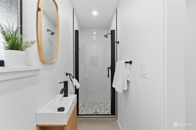 bathroom with sink, an enclosed shower, and tile patterned flooring