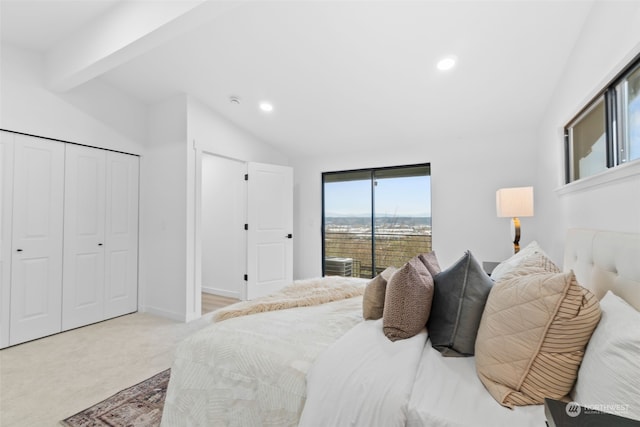 carpeted bedroom with a closet and lofted ceiling with beams