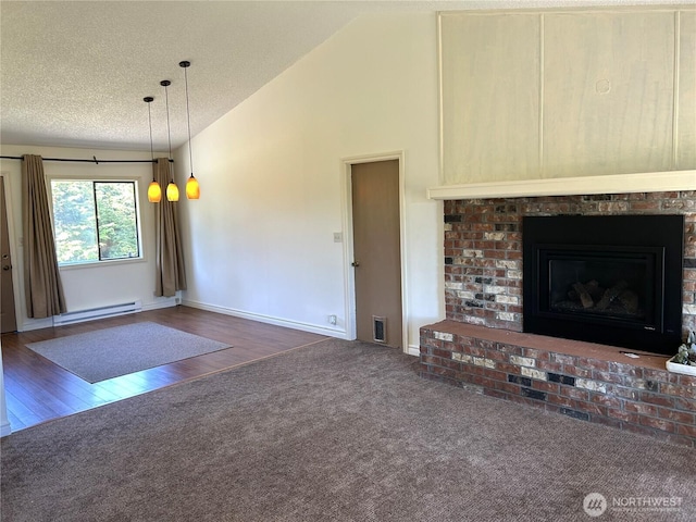 450 Spruce St, Friday Harbor, WA 98250 - unfurnished living room featuring a baseboard heating unit, lofted ceiling, a textured ceiling, carpet, and a brick fireplace