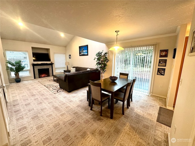 dining area featuring lofted ceiling, crown molding, light colored carpet, and a textured ceiling