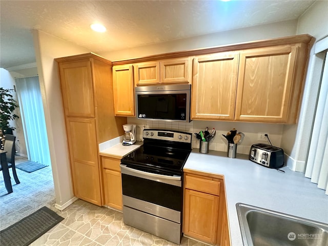 kitchen with backsplash and stainless steel appliances