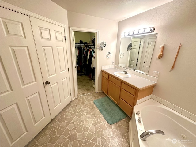 bathroom with a bath and vanity